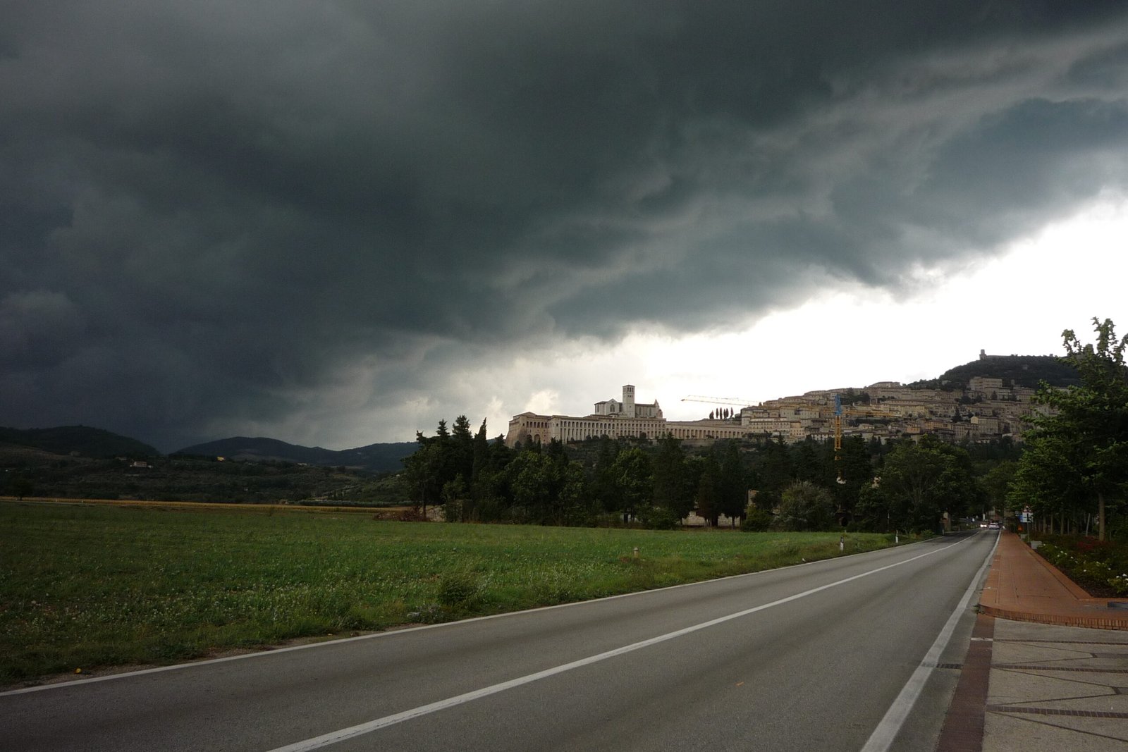 Assisi on its hillside under a heavy sky
