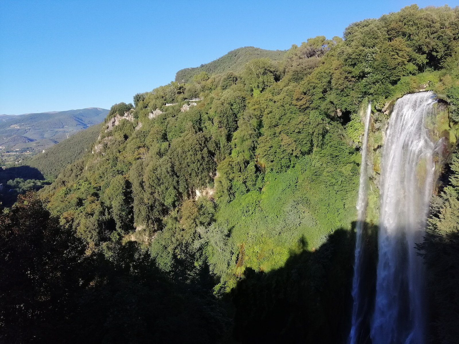 The Cascata delle Marmore seen across a wooded valley near Terni