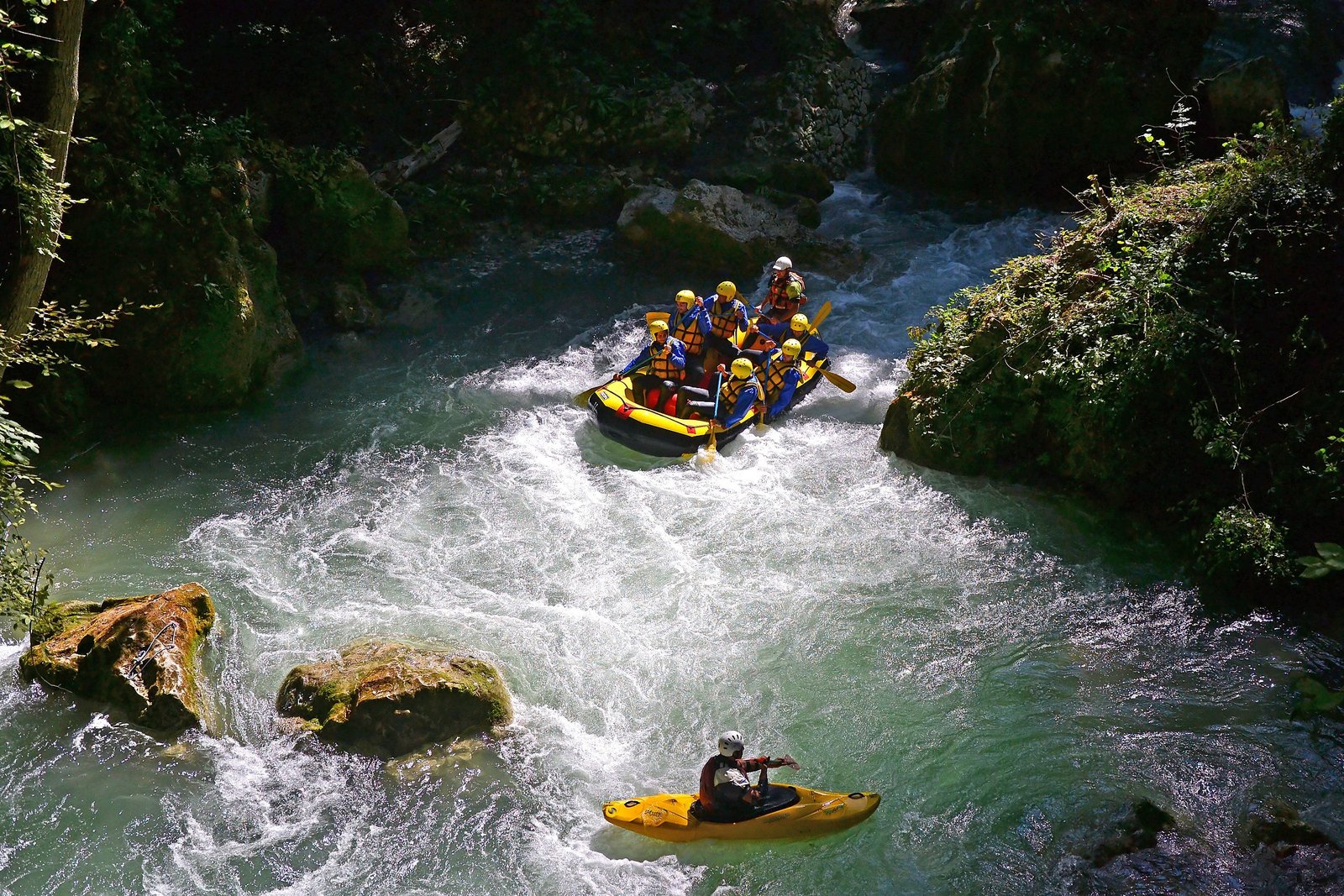 A raft and a kayaker in the whitewater of the Nera gorge below Marmore Falls