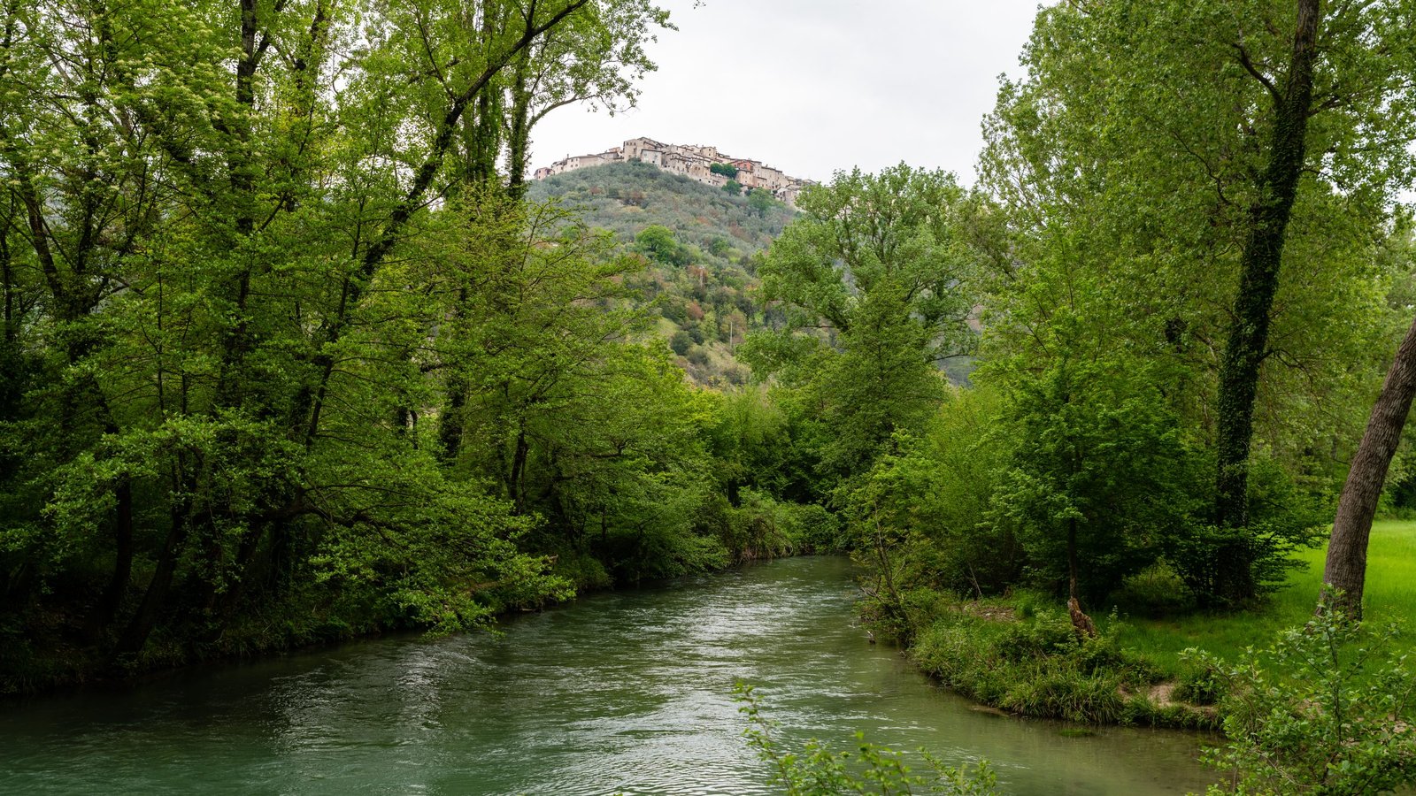 The river Nera running past Montefranco in the Valnerina, wooded banks on both sides