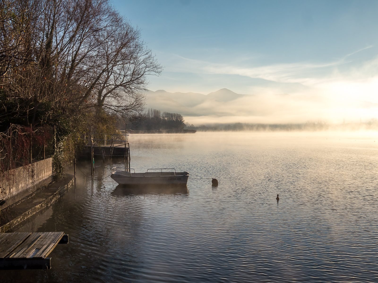 Dawn mist over Lake Piediluco, the far shore soft behind the water