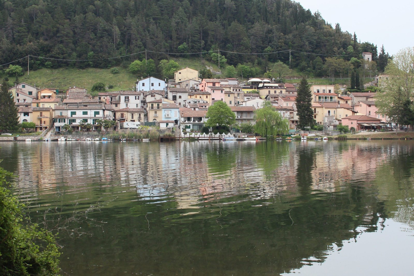 The lakefront row of houses at Piediluco reflected in the still water of the lake
