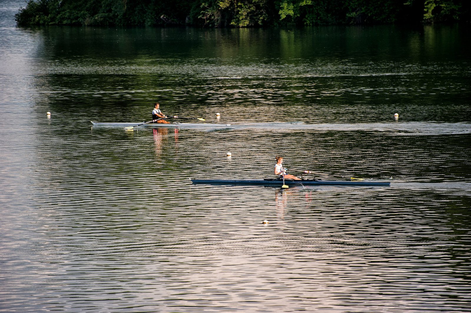 Two rowing sculls on the flat water of Lake Piediluco