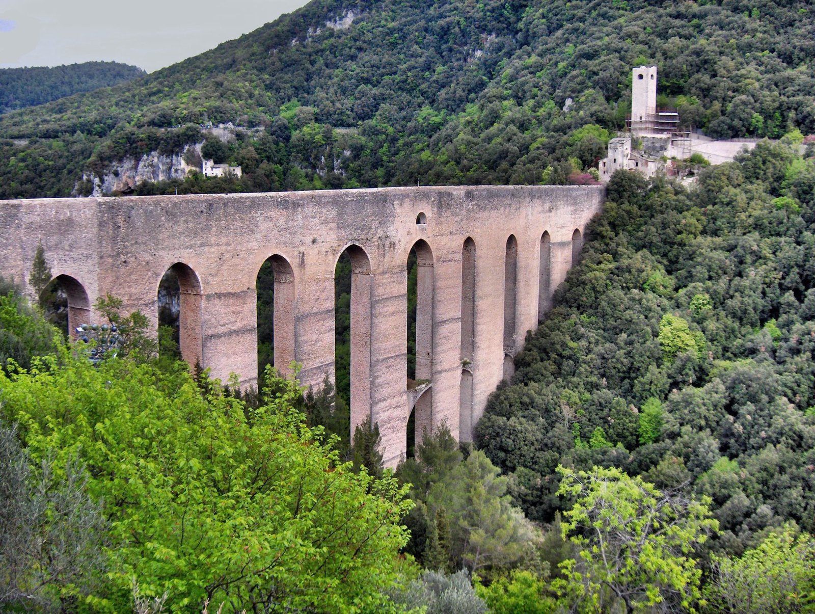 The Ponte delle Torri at Spoleto, a tall arched bridge spanning a wooded gorge